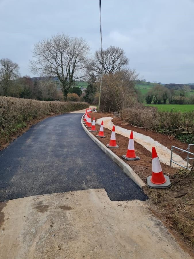 Section of new tarmac on an old road